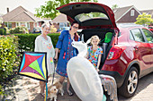 Lesbian couple and daughter loading car