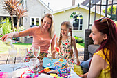 Lesbian couple doing craft project with daughter