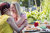 Lesbian couple enjoying lunch at patio table