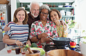 Portrait Senior friends cooking in kitchen