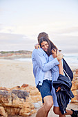 Affectionate couple hugging at beach