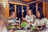 Friends enjoying dinner in cabin