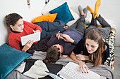 Student roommates studying on bed