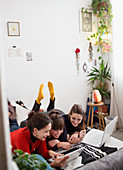 Young students studying on bed