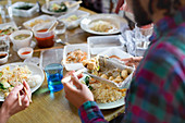 Young man eating takeout Chinese food