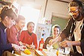Young adult friends making cocktails