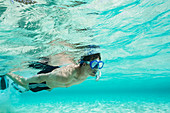 Young man snorkelling underwater