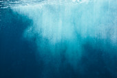 Underwater spray in blue ocean