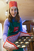 Portrait enthusiastic girl baking muffins