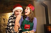 Brother and sister eating Christmas cookies