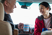 Happy couple drinking coffee in motor home