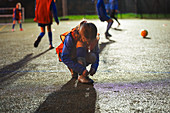 Girl soccer player tying shoe