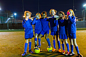 Portrait girls soccer team drinking water