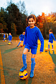 Portrait girl practicing soccer