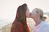 Lesbian couple kissing on beach