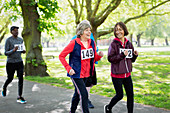 Active senior women friends power walking