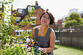 Portrait woman gardening in yard
