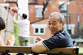 Portrait senior man drinking tea with family