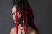 Portrait serious young woman with red braids