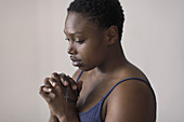 Serene woman praying with rosary