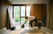 Construction worker using electric saw