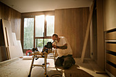 Construction worker using electric saw