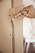 Close up construction worker plastering wall