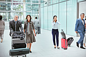 Business people with luggage in airport