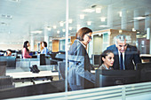 Business people working at computers in office