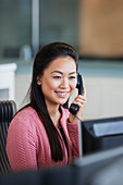 Smiling businesswoman talking on telephone