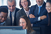Smiling business people working at computer