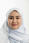 Young woman in blue silk hijab