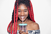 Portrait teenage girl drinking smoothie