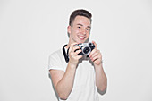 Portrait teenage boy with retro camera