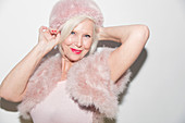 Portrait elegant senior woman wearing pink fur