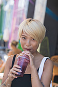 Young woman drinking smoothie