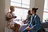 Young women friends drinking coffee