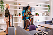 Young women friends with suitcases