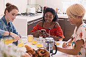 Young women friends enjoying breakfast