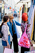 Young women friends shopping