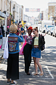 Friends posing for photograph on street