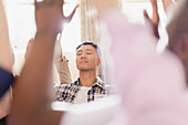 Serene man praying with arms raised