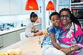Portrait affectionate grandmother and grandson in kitchen