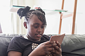 Tween girl texting with smart phone
