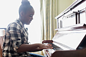 Teenage girl playing piano