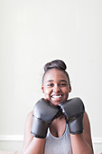 Portrait teenage girl wearing boxing gloves