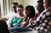 Lesbian couple with family on sofa