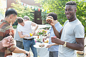 Portrait man enjoying barbecue with friends