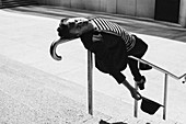 Portrait man leaning on urban railing