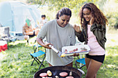 Mother and daughter barbecuing